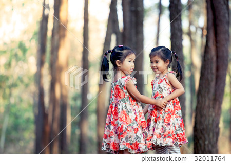 Two asian little girls having fun to play together Two asian little girls having fun to play together 32011764