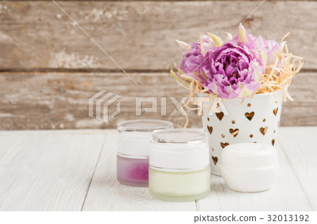 Beauty products, cosmetics, lit candle  32013192