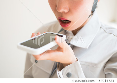 A female worker talking to a smartphone A female worker talking to a smartphone 32015783
