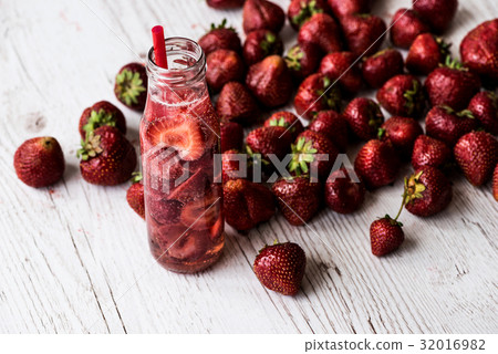 detox water in bottle with strawberry on white detox water in bottle with strawberry on white 32016982