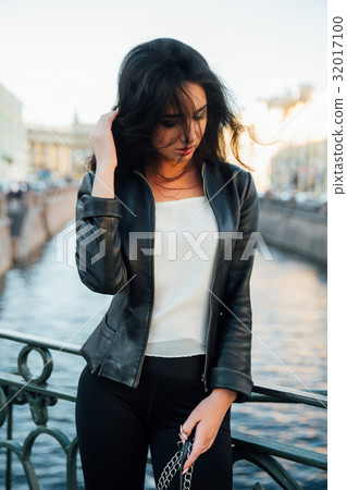 Portrait of a beautiful sexy brunette posing on a 32017100