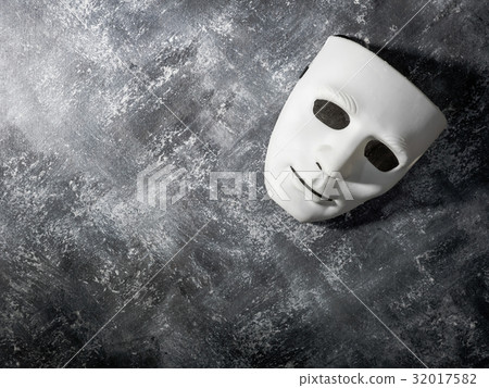 White mask on gray grunge background. 32017582