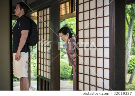 一位女士建議外國遊客到他們的房間 一位女士建議外國遊客到他們的房間 32019327