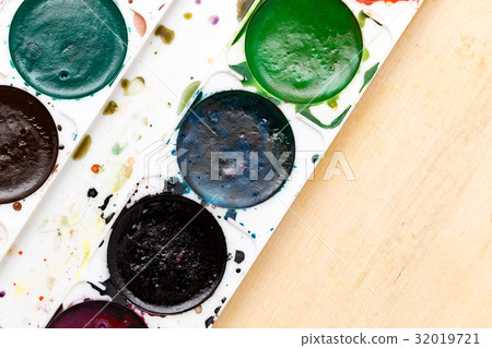 Old used paints on a wooden background Old used paints on a wooden background 32019721