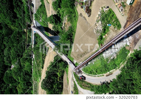 Construction of a dam under the summer sky Construction of a dam under the summer sky 32020703