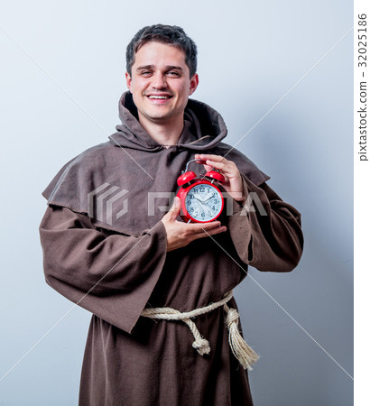 Portrait of Young catholic monk with alarm clock Portrait of Young catholic monk with alarm clock 32025186