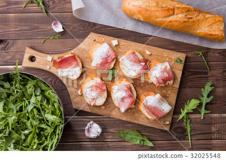 Baguette , bacon on cutting board Baguette , bacon on cutting board 32025548
