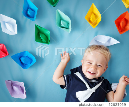 boy playing with paper ships 32025939