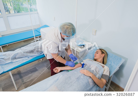 Professional nurse making an injection to a woman 32026887