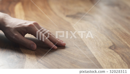 closeup of man hand checking hard wood surface 32028311