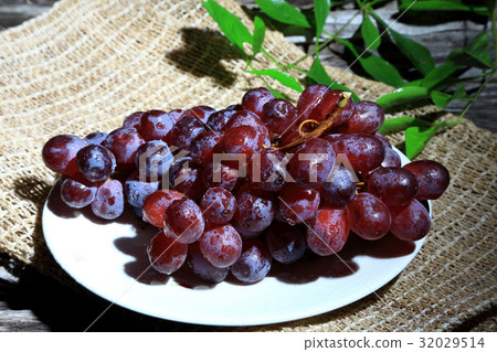 Red grapes on wooden board background, Dark tone. 32029514