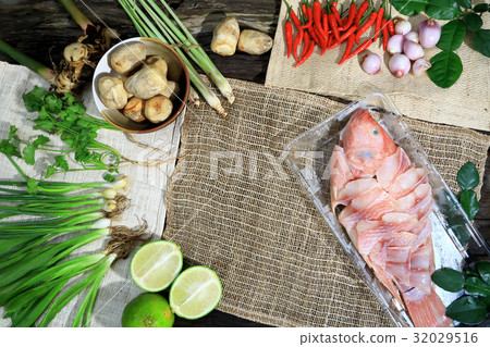 Preparing cooking Thai spicy sour soup with fish. 32029516