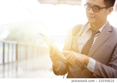 Businessman and tablet pc, train station. Businessman and tablet pc, train station. 32030628