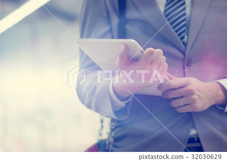Business people and tablet pc, train station. 32030629