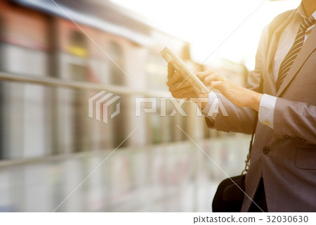 Business people and tablet pc, railway station. Business people and tablet pc, railway station. 32030630