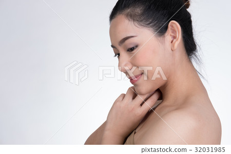 Portrait of a smiling young woman with natural make-up. beautiful asian girl standing against white background. Skincare, healthcare, studio shot. Portrait of a smiling young woman with natural make-up. beautiful asian girl standing against white background. Skincare, healthcare, studio shot. 32031985