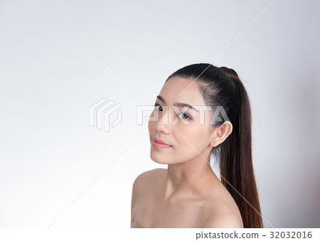 Portrait of a smiling young woman with natural make-up. beautiful asian girl standing against white background. Skincare, healthcare, studio shot. Portrait of a smiling young woman with natural make-up. beautiful asian girl standing against white background. Skincare, healthcare, studio shot. 32032016