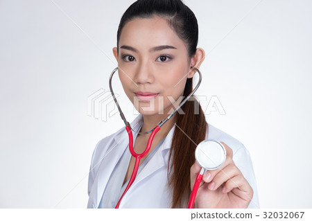 female doctor showing stethoscope for checkup over white background. physician or medical practitioner holding stethoscope to auscultate breath in medical visit 32032067