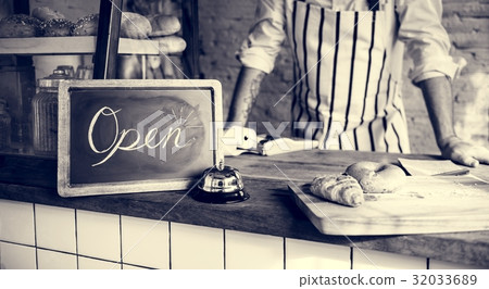 African Man with Open Sign in Bakery Shop African Man with Open Sign in Bakery Shop 32033689