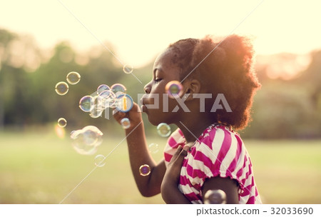 Kid with bubbles in a park 32033690
