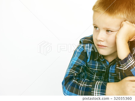 Young boy sitting and being serious Young boy sitting and being serious 32035360