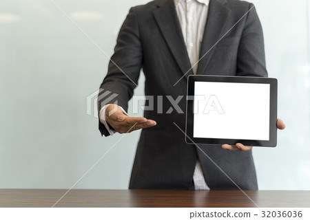 Businessman using his tablet in the office Businessman using his tablet in the office 32036036