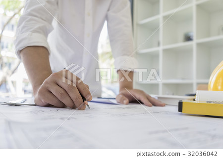Engineer sketching architectural on blueprint Engineer sketching architectural on blueprint 32036042