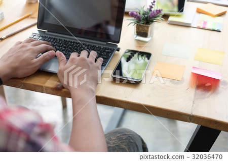 student sitting in room and typing on keyboard while looking at computer, handsome young asian man using laptop in cafe student sitting in room and typing on keyboard while looking at computer, handsome young asian man using laptop in cafe 32036470