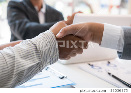 Business people shaking hands after finishing up a meeting. Businessman handshaking after conference. teamwork, partnership, collaboration, corporate concept. 32036575