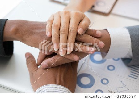 young businessman joining hand, business team touching hands together - unity, harmony, teamwork, partnership, collaboration, corporate concept. young businessman joining hand, business team touching hands together - unity, harmony, teamwork, partnership, collaboration, corporate concept. 32036587