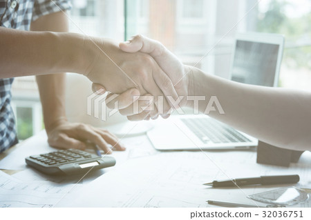 Architect and customer shaking hands at workplace. Engineer handshaking with partner for successful deal in building project development. business teamwork, cooperation, success collaboration concept 32036751