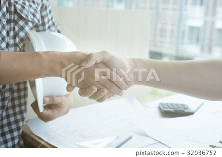 Architect and customer shaking hands at workplace. Engineer handshaking with partner for successful deal in building project development. business teamwork, cooperation, success collaboration concept 32036752