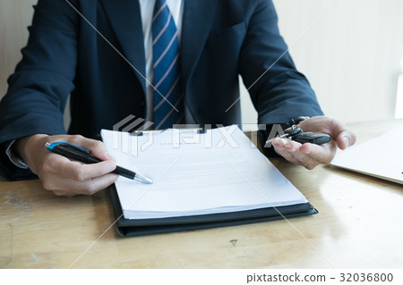 businessman present signing sales contract with car key to customer at office. ownership, customer buying and salesman selling transportation concept. businessman present signing sales contract with car key to customer at office. ownership, customer buying and salesman selling transportation concept. 32036800
