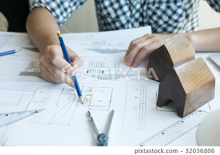 Architect working on real estate project at workplace. Male engineer hand working with living house blueprint at office. Business, people, construction and building concept Architect working on real estate project at workplace. Male engineer hand working with living house blueprint at office. Business, people, construction and building concept 32036806