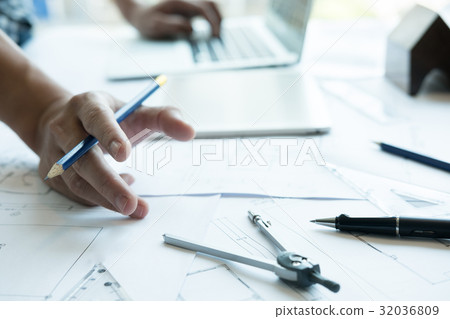 Architect working on real estate project at workplace. Male engineer hand working with living house blueprint at office. Business, people, construction and building concept 32036809
