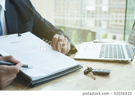 businessman present signing sales contract with car key to customer at office. ownership, customer buying and salesman selling transportation concept. businessman present signing sales contract with car key to customer at office. ownership, customer buying and salesman selling transportation concept. 32036810