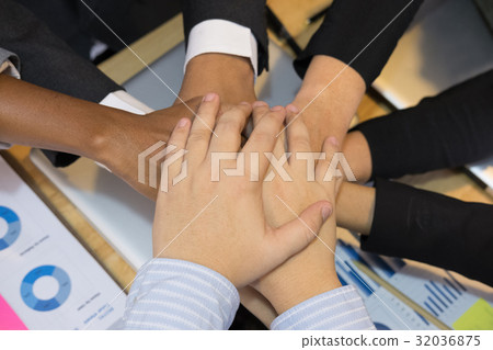 young businessman joining hand, team of business people touching hands together - unity, harmony, teamwork, partnership, collaboration, corporate concept. 32036875