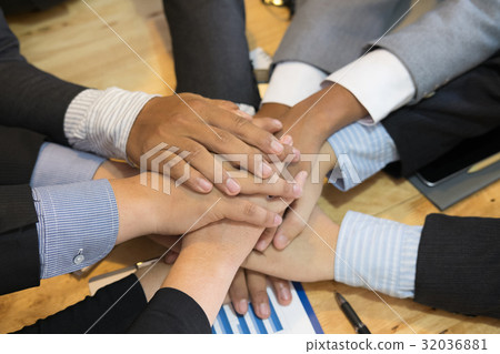 young businessman joining hand, team of business people touching hands together - unity, harmony, teamwork, partnership, collaboration, corporate concept. young businessman joining hand, team of business people touching hands together - unity, harmony, teamwork, partnership, collaboration, corporate concept. 32036881