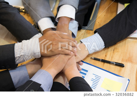 young businessman joining hand, team of business people touching hands together - unity, harmony, teamwork, partnership, collaboration, corporate concept. young businessman joining hand, team of business people touching hands together - unity, harmony, teamwork, partnership, collaboration, corporate concept. 32036882