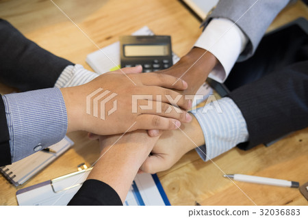 young businessman joining hand, team of business people touching hands together - unity, harmony, teamwork, partnership, collaboration, corporate concept. young businessman joining hand, team of business people touching hands together - unity, harmony, teamwork, partnership, collaboration, corporate concept. 32036883