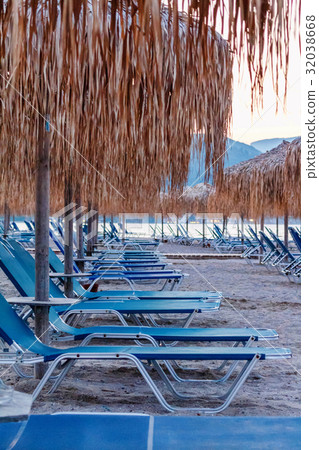 Beach chairs at seacost with umbrellas 32038668