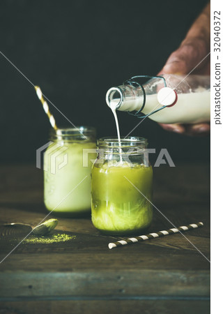 Cold refreshing summer iced coconut matcha latte 32040372