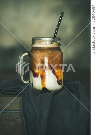 Iced caramel macciato coffee with milk in jar 32040494