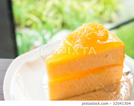 Closeup orange cake on wood table 32041304
