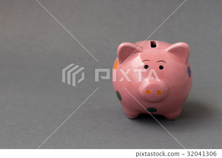 Closeup pink ceramic piggy bank on dark background Closeup pink ceramic piggy bank on dark background 32041306