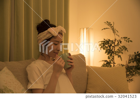 A young woman holding tea at night 32041523