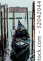 A black gondola boat mooring in the sea, Venice 32042044