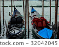 Black and white gondola boats mooring in the sea 32042045
