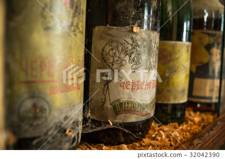 Old bottles of wine in old cellar Old bottles of wine in old cellar 32042390