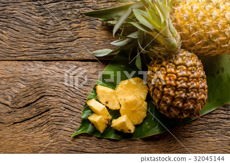 pineapple fruit cut on green leaf pineapple fruit cut on green leaf 32045144